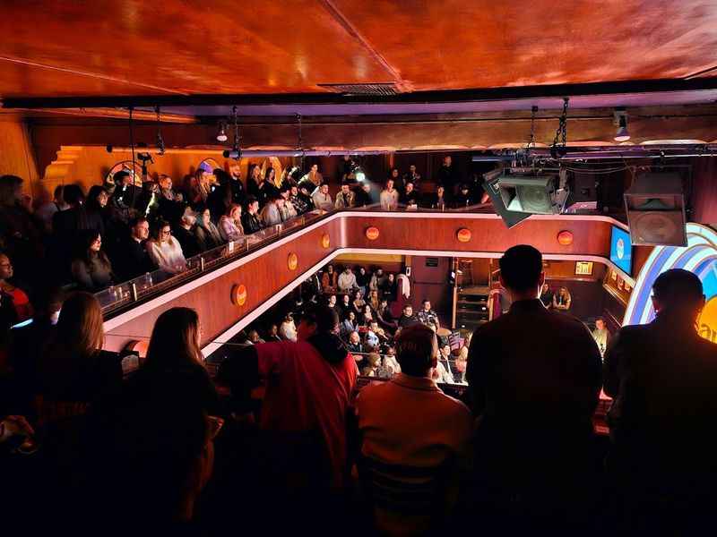 a big red painted room with a crowd