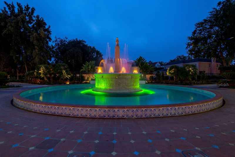 a fountain lit up with green lights