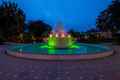 a fountain lit up with green lights