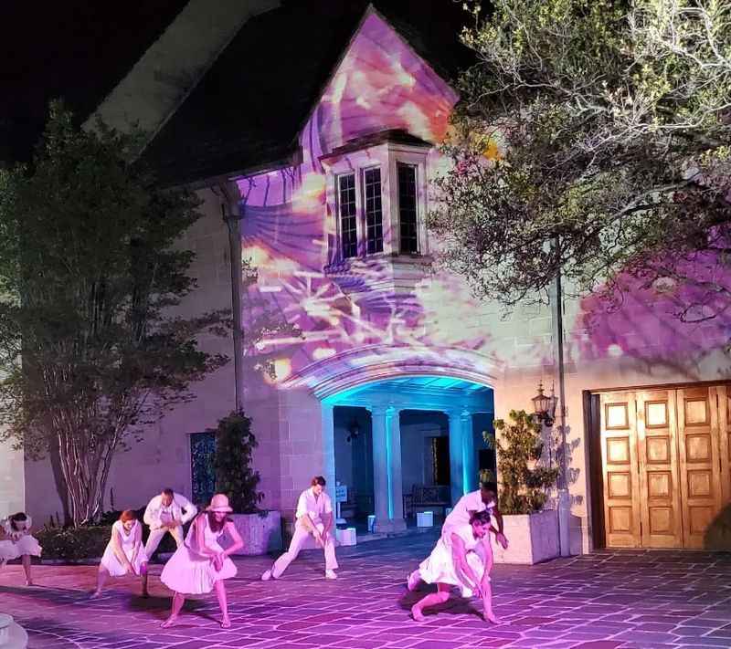 a group of dancers in front of a building