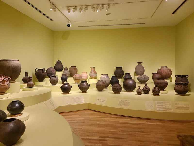 a room with a lot of vases on display