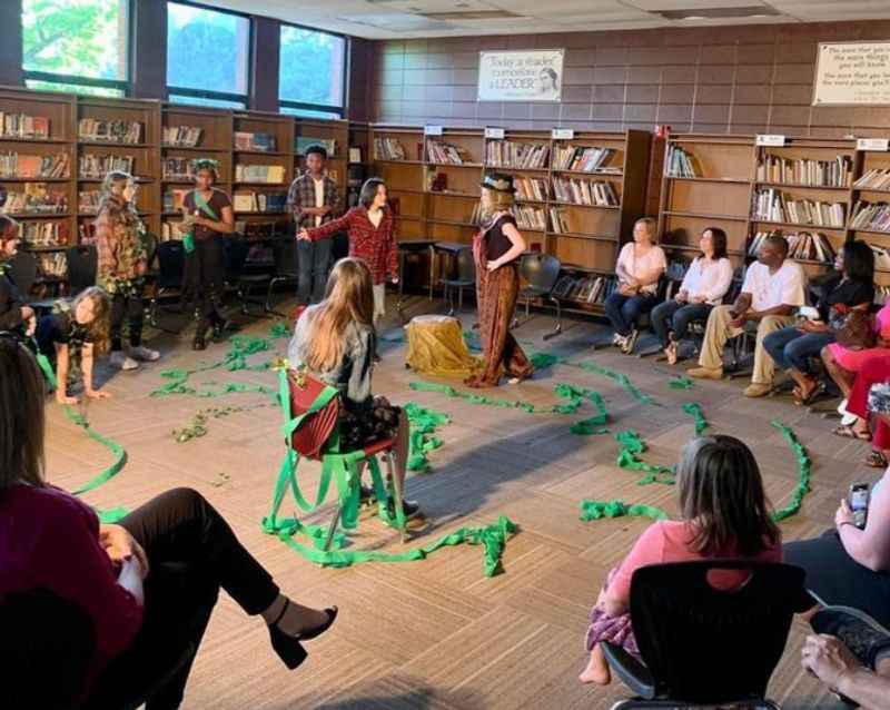 a group of people sitting in a library