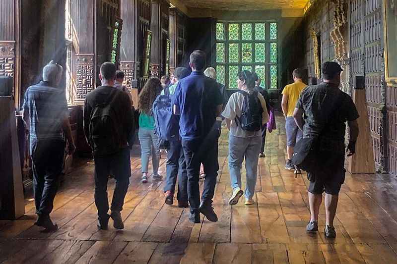 group of people walking on the hallway