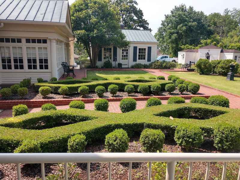 a garden with hedges and bushes