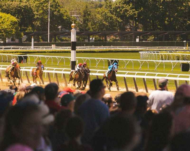 a horse race with people watching