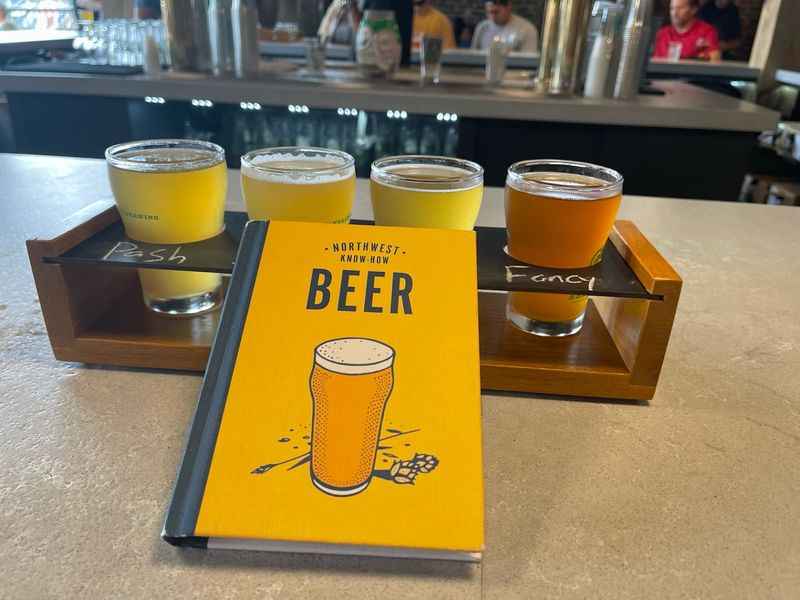 a book and two glasses of beer on a table