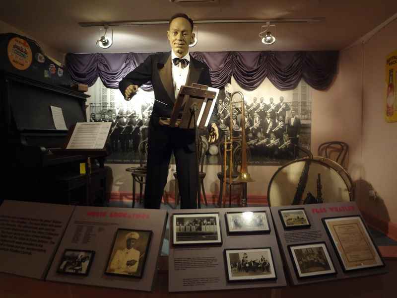 statue of man in a suit and tie in Jazz Hall