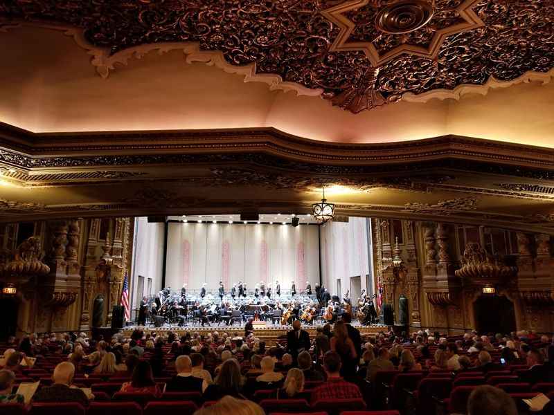 large theater with a stage and a band