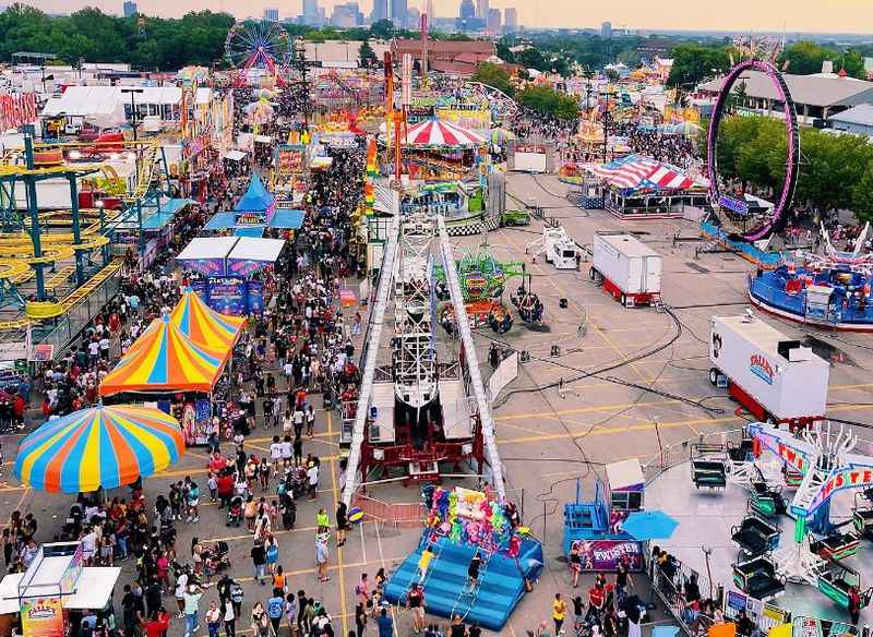 a large crowd of people at an outdoor fair