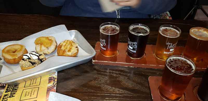 a tray of donuts and a tray of beer