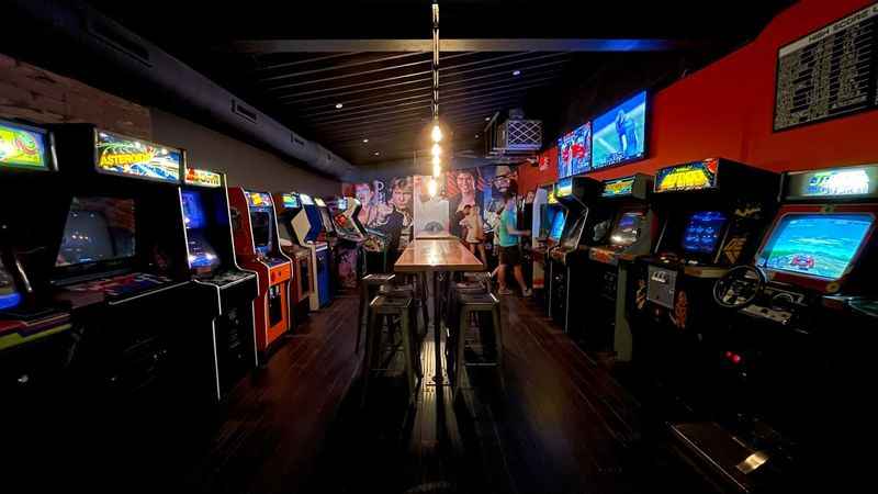 a room with several video games and a bar