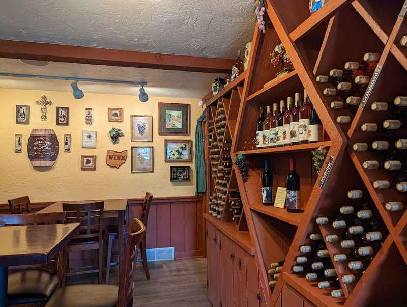 wine rack in a restaurant with a table and chairs