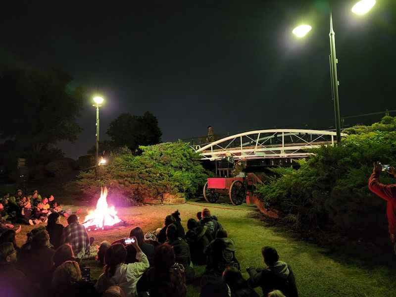 people sitting around a fire pit at night