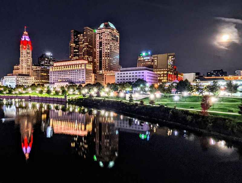 colorful building at night reflects on the water