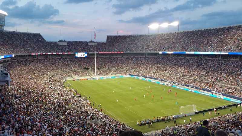 a large stadium filled with people watching a soccer game