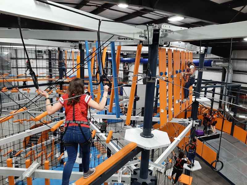 a woman in the large indoor park for adventure