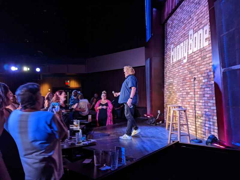 a man standing on a stage with people watching