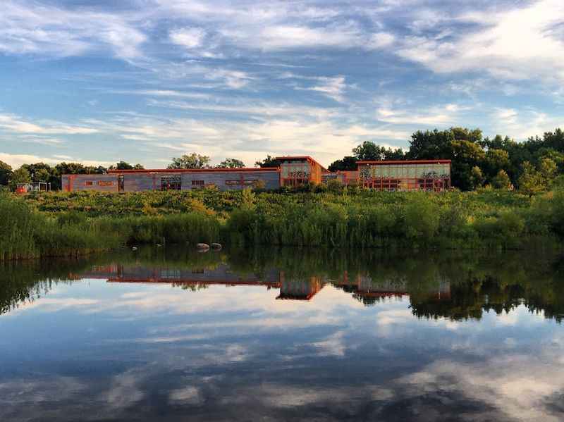 a body of water with a building in the background