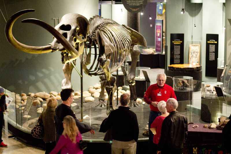 a group of people standing around a museum