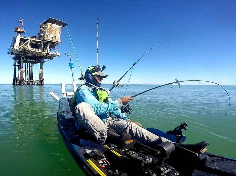 man in the kayak fishing on the water