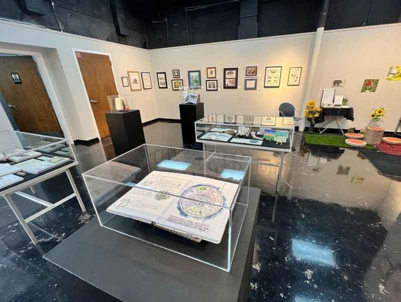 a room with a glass table and a large display case