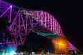 the bridge lit up in purple and green