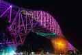 the bridge lit up in purple and green