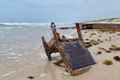 upside-down rusty chair on the beach