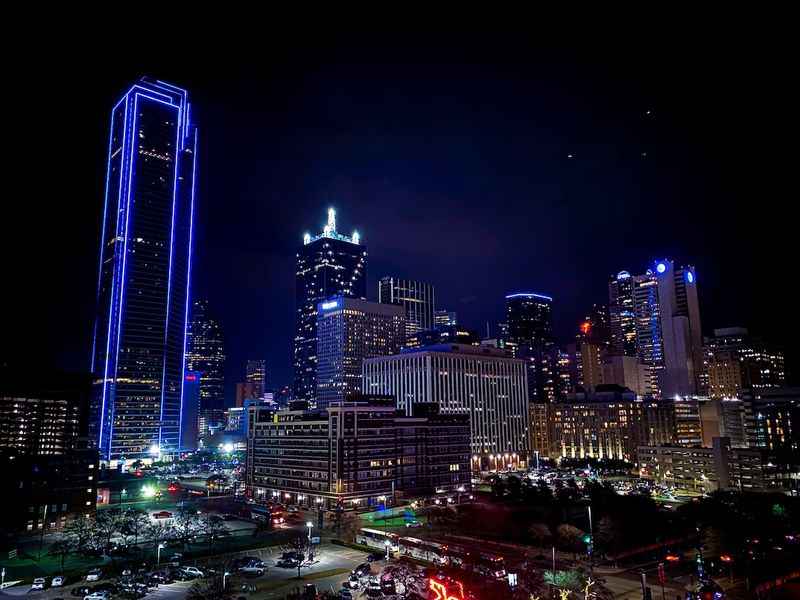 a city at night with lights from the buildings