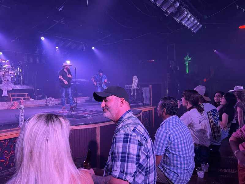 the band perform at the stage with people in front