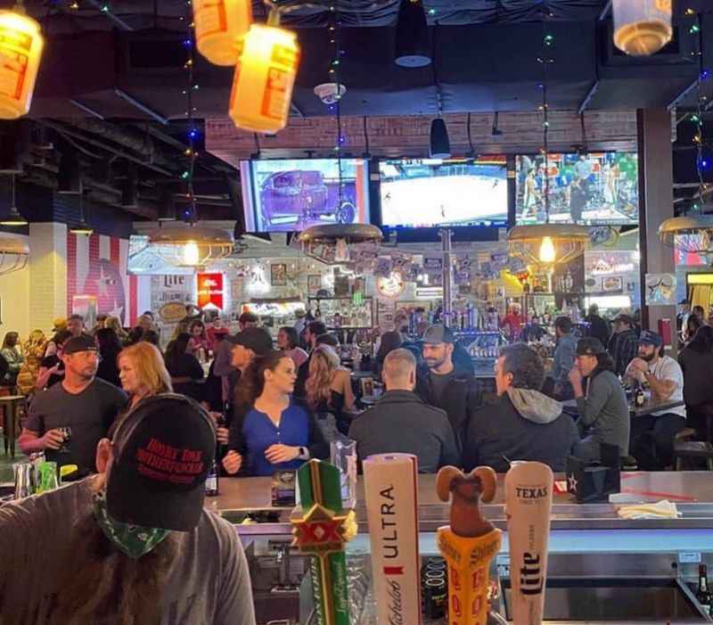 a crowded bar with people sitting at tables