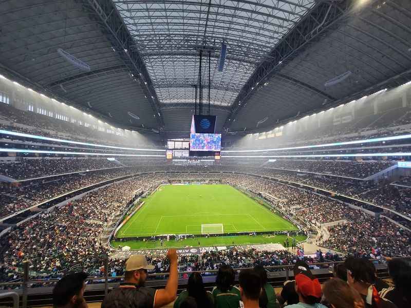 a large stadium filled with people watching a soccer game