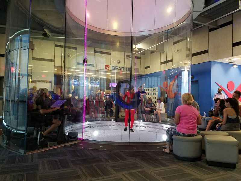 group of people sitting around the wind tunnel