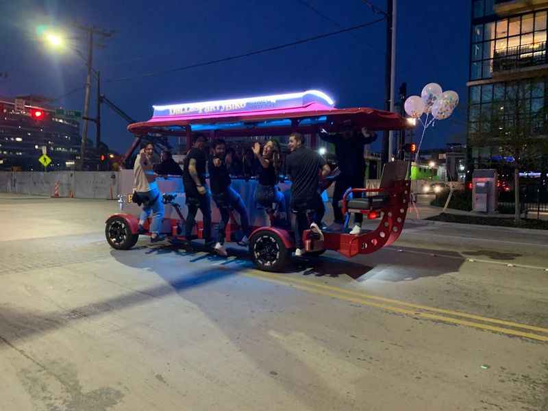 a group of people riding on a red and blue vehicle