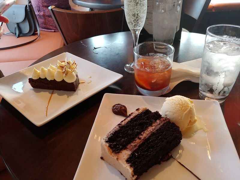 two plates with desserts on them on a table