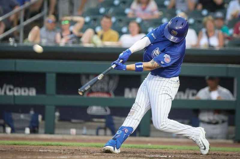 a baseball player swinging at a ball during a game