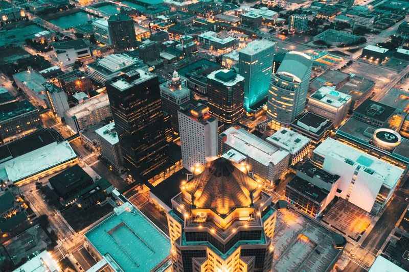 aerial view of city at night with lots of buildings