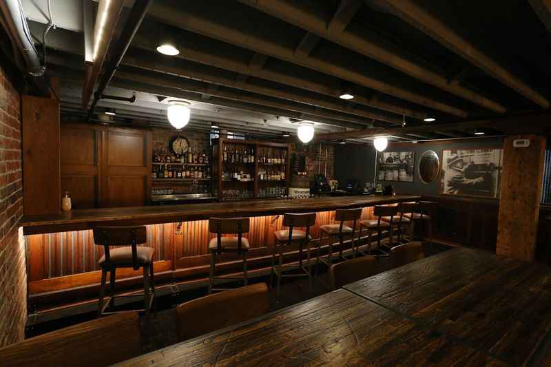 a bar with wooden tables and chairs