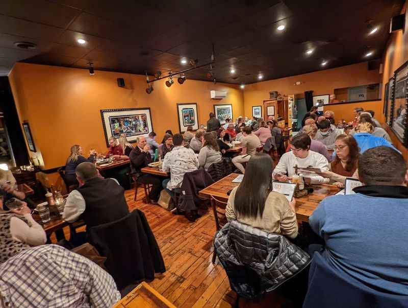 a group of people sitting at tables in a restaurant