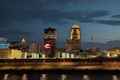 a city skyline at night with a river in front