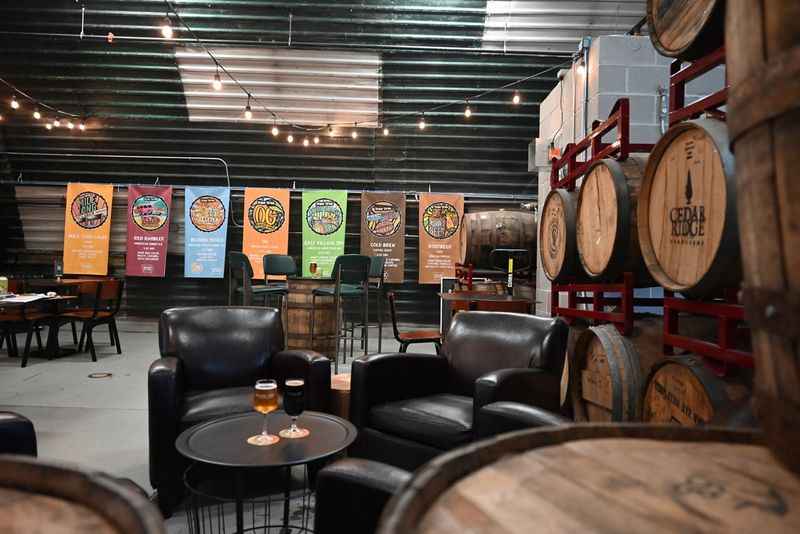 a room with several wooden barrels and tables