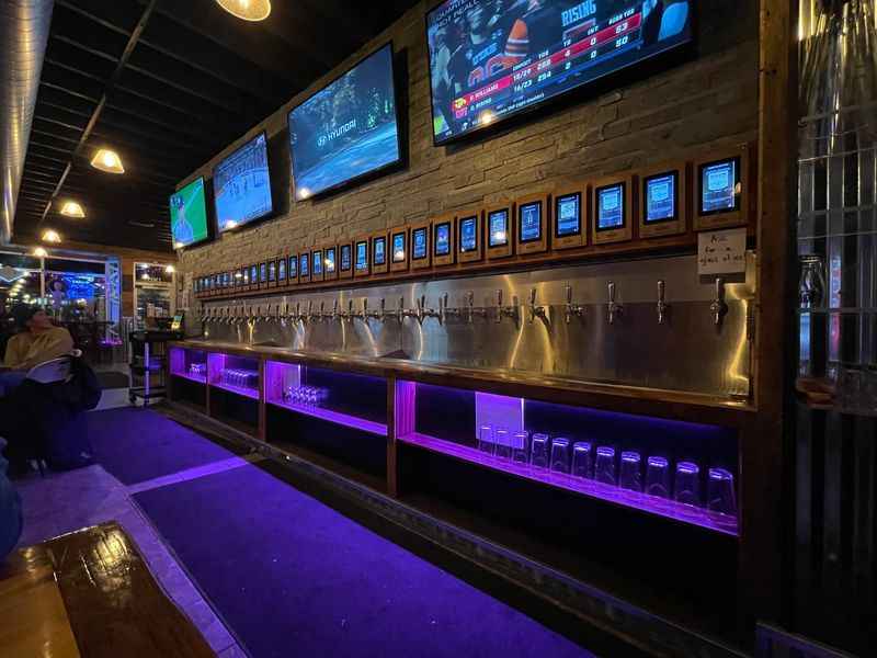 a bar with a tv and a purple light
