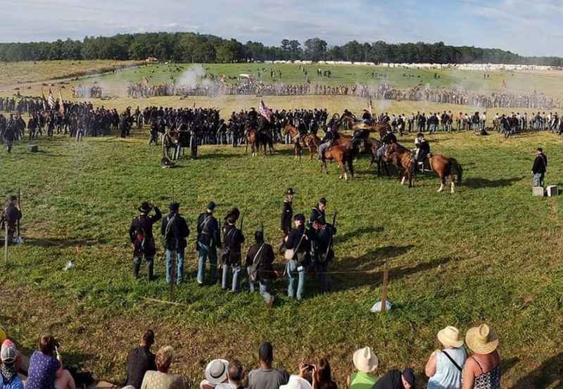 a crowd of people watching a horse race