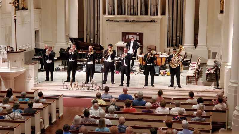 a band playing in a church with people watching