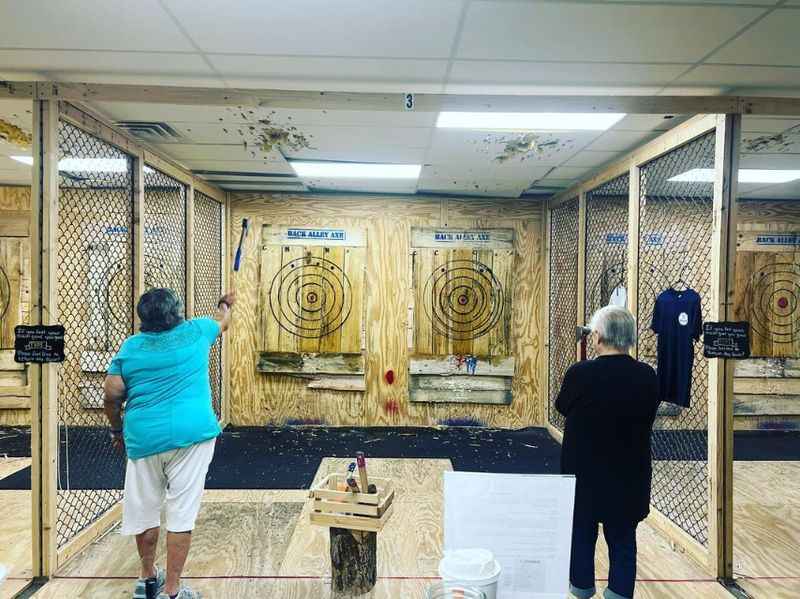two men are practicing archery in a room