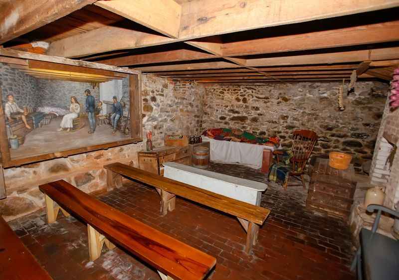 wooden table and painting on the wall of the room