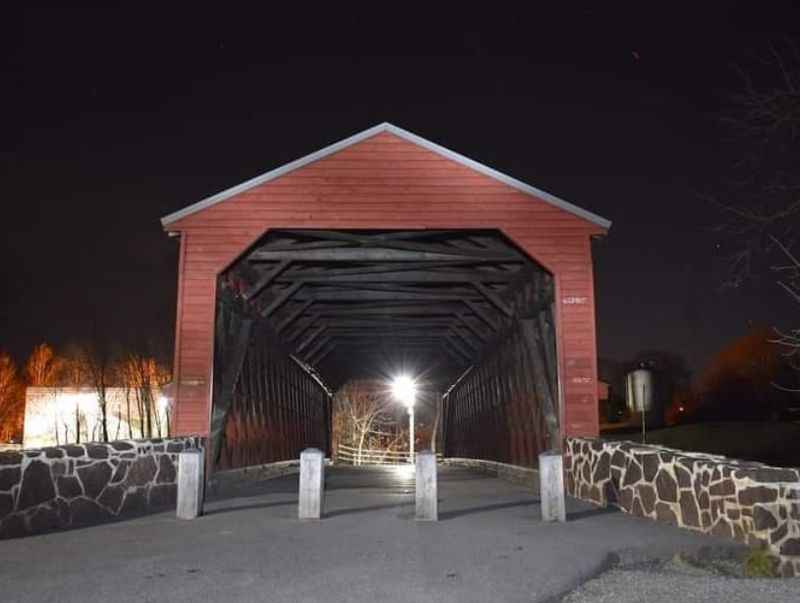 a red covered bridge at night