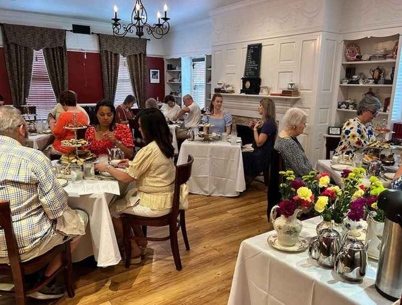 a group of people sitting at tables in a restaurant