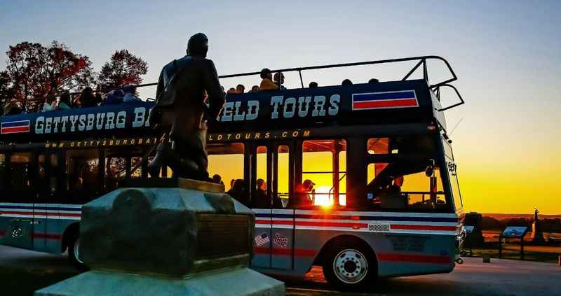 a bus with a bunch of passengers on top