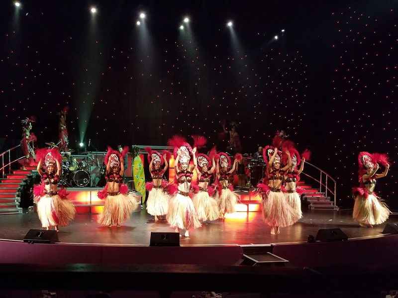 a group of dancers on stage with lights